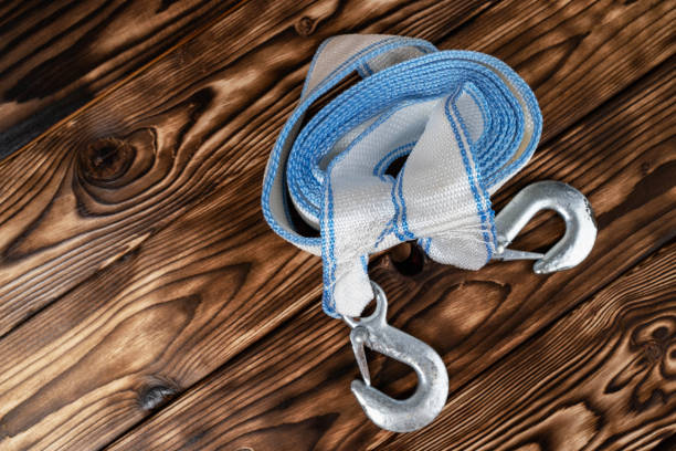 Roll of climbing rope with carabiner on white background