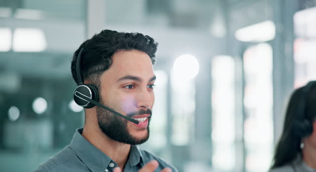 Man, headset or mic in helpdesk, call centre or telemarketing as crm, communication or support. Male agent, tech or headphones to talk business, sales or advice as happy, telecom or customer care