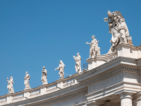 Statues of saints and apostles on colonnade of St. Peter's basilica, Vatican city, Italy. Horizontal view
