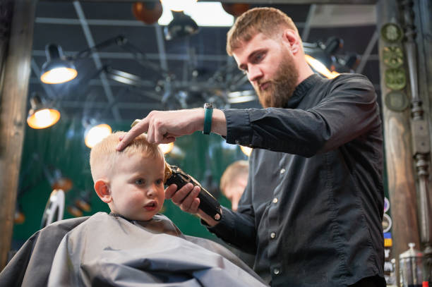 istock Barber using comb and shaver to cut hair. 2148153761
