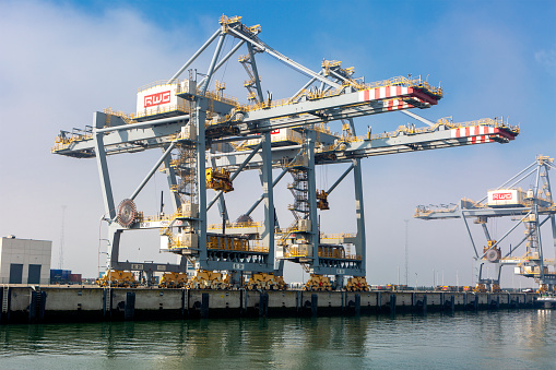 Rotterdam, The Netherlands: March 06, 2024: Large gantry cranes - port of Rotterdam - Maasvlakte. The Maasvlakte is a massive westward extension of the Europoort port and industrial facility within the Port of Rotterdam.