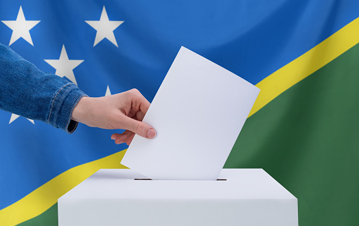 Businessman or politician making speech from behind the pulpit with national flag on background - South Africa