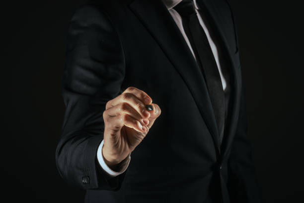 istock Businessman touch with digital pen a futuristic display, write on a virtual screen. Gesture concept 2148156594