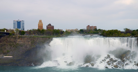 Modern tourist destination Niagara Falls. American Falls overlooking outskirts of city of Niagara Falls. Explore tourist destination that showcases beauty of Niagara Falls Travel destinations concept.