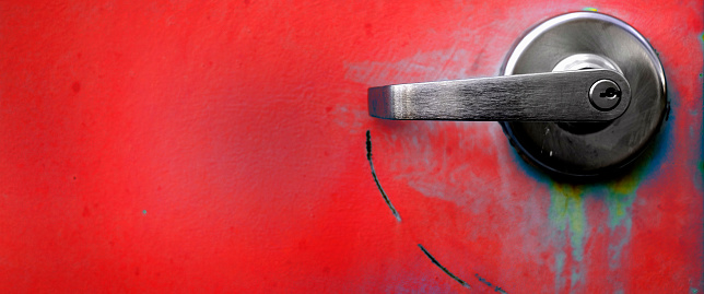 Red industrial doors textured metal door with handles for opening and locks for security