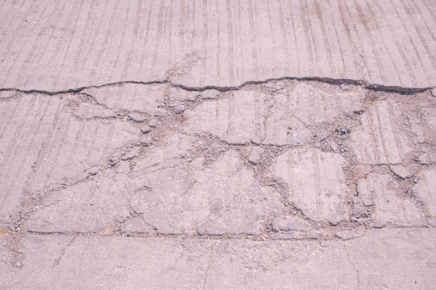 istock The old damaged concrete road background with broken and crack texture on surface 2148159272
