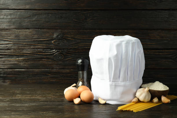 Composition with chef hat for concept of cooking, space for text