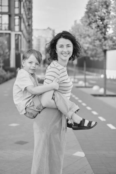 istock Young mother and son smiling looking at camera in modern residential complex 2148160792