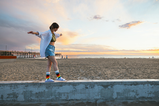 Person wearing rainbow socks during the Pride Month walking by the beach in California, United States.