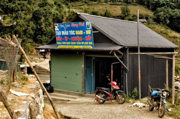 This photograph was taken on November 19, 2023 in Sapa, northern Vietnam. The photograph corresponds to one of the sheds that protect the way of life of the ethnic groups, sometimes they act as supermarkets to supply the population, other times as their own homes and on many occasions both. Sapa is the perfect place to discover the landscapes of rice fields that are cultivated on terraces on the slopes of the mountains. There we can learn about the culture of minority ethnic groups and their crafts. The photographs reflect the route that was taken crossing the rice fields in the company of ethnic women.