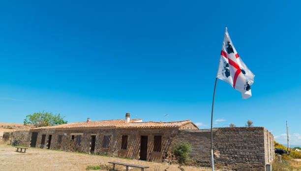 istock Sardinia flag with an abandoned building  on the background 2148162555