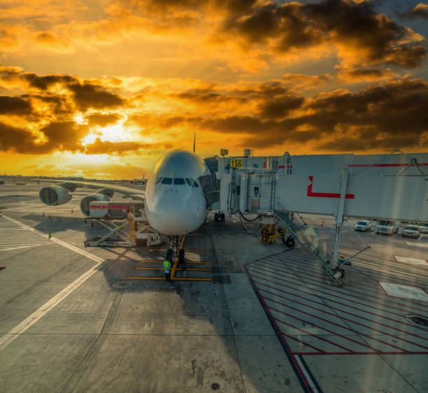 istock Aircraft linked to an aerobridge under a colorfu sky 2148162841