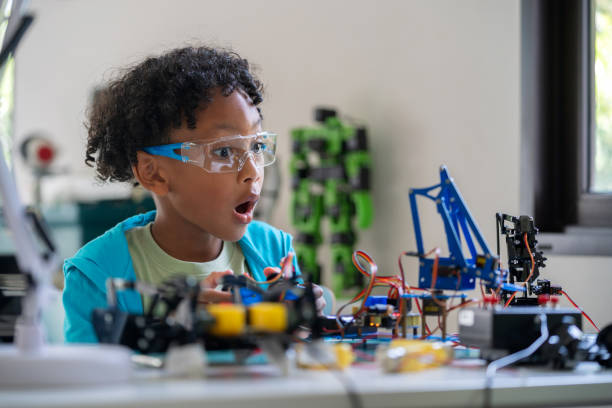 istock Black children is engaging in online e-learning activities. They are excitedly experimenting with assembling robots and using coding to give commands, showcasing their enthusiasm and creativity in education. 2148162963