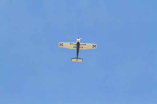 Single engine plane flying with a beautiful blue sky in Rio de Janeiro, Brazil.