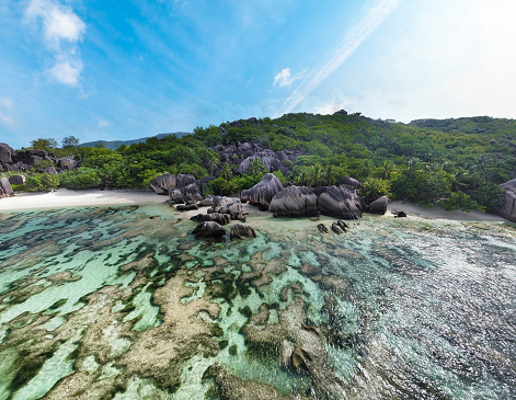 Aerial view of world famous Anse Source d'Argent beach with coral reef and granite boulders. La Digue island, Seychelles