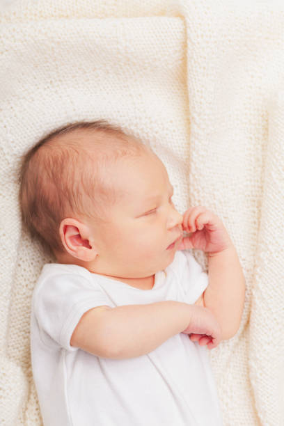 istock Newborn Baby Asleep on Cream Blanket 2148165902