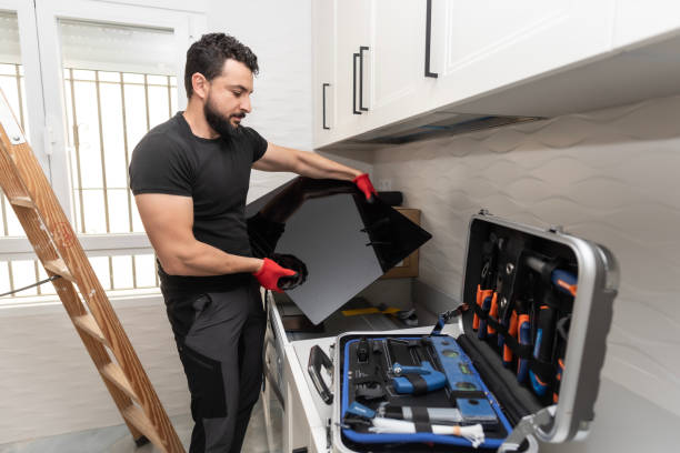 istock a man assembles his kitchen by placing furniture: Preparation and installation of ceramic hob 2148166108