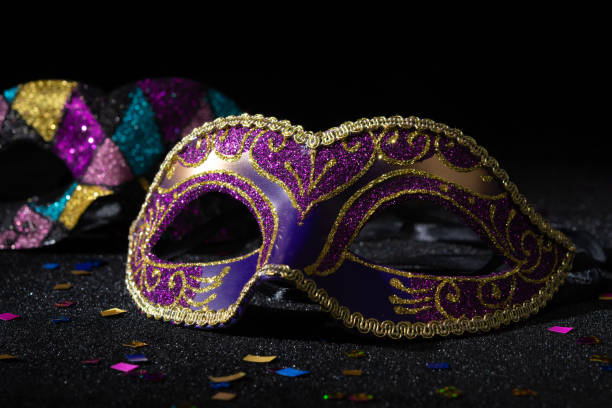 istock Carnival mask with confetties on black background. 2148166881