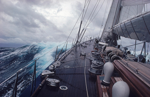 The sailing yacht rolls with a large wave during a storm in the Atlantic Ocean