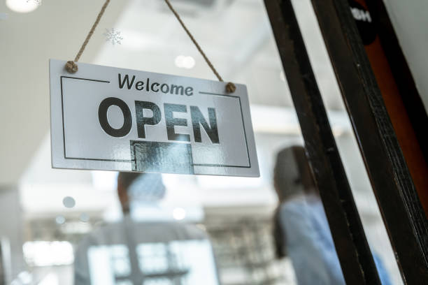 Open sign on the window at the front door at coffee shop