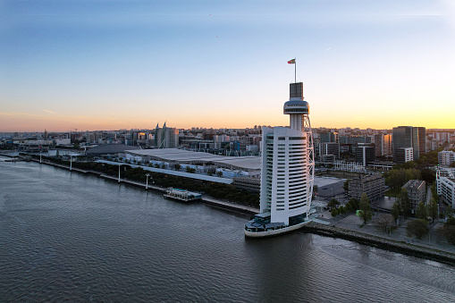 A photographer used an aerial camera to capture the Vasco da Gama Tower. The Vasco da Gama Tower is the tallest building in Portugal, with a height of 145 meters. It is located in the Parque des Nations in Lisbon, near the Tagus River.