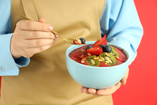 istock Woman in apron with smoothie with different ingredients 2148168931