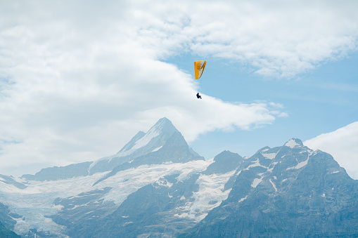 Paragliding in Swiss Alps at sunset in autumn