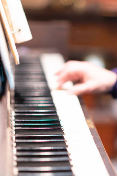 fingers of a man playing the piano