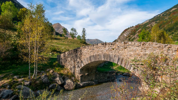 Gavarnie, Hautes-Pyrénées, France - October 13, 2023: Medieval stone bridge over the Gave de Gavarnie river