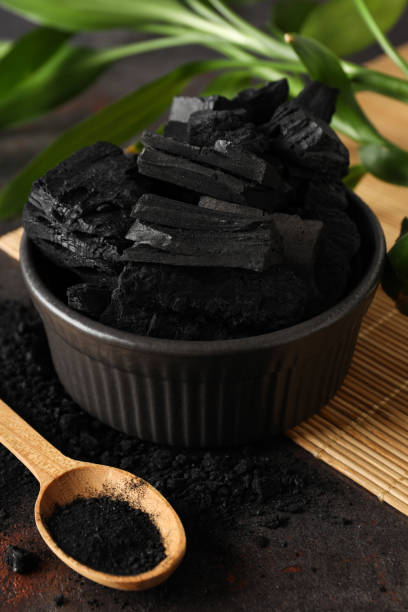 istock Bowl with charcoal and spoon with powdered charcoal, close up 2148171356