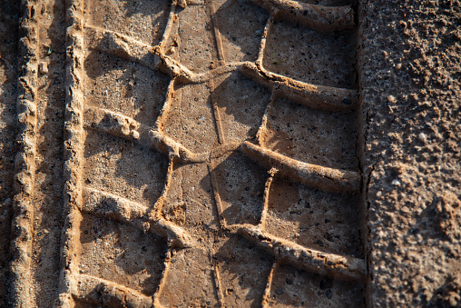 Vehicle tire tracks on the dirt road. Marks in the sand. Sand floor. Vehicle tracks. Off road.