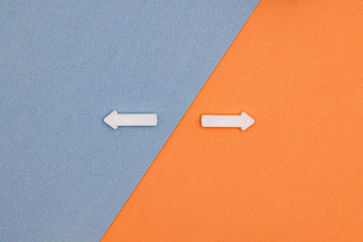 Orange and Blue Separation with White Arrows Pointing in Different Directions