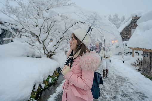 Beautiful woman tourists enjoying their trip with thick snow Japan at winter