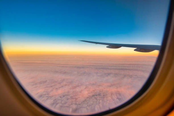 istock Silhouette wing of an airplane at sunset view through the window. 2148173019