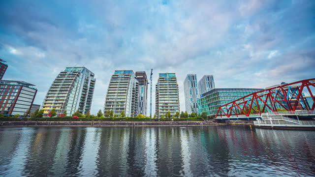 Time lapse Cityscape of Media City UK waterfront around Salford Quays and Big Red Bridge in Manchester at night, England, United Kingdom