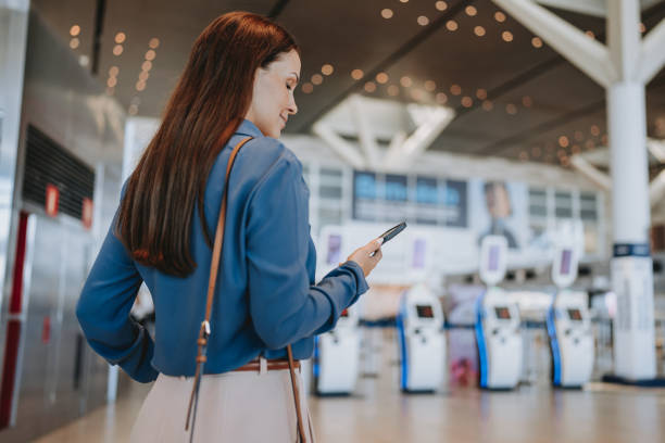istock A woman at the airport using smartphone 2148174434