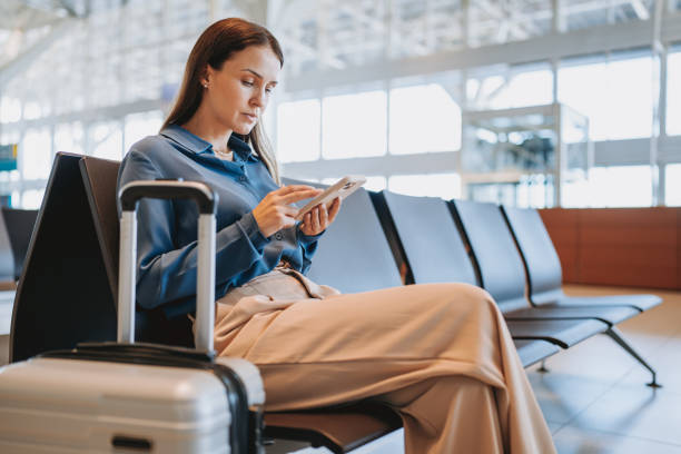 istock A woman at the airport using smartphone 2148174437