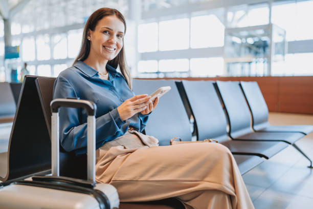 istock A woman at the airport using smartphone 2148174445