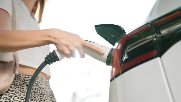 istock Sunlight backlit brighten young woman travel with EV car innards 2148174781