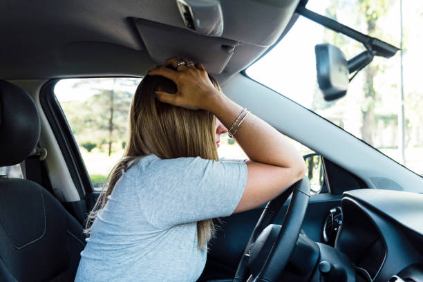 istock Stressed, worried and depressed woman sitting inside her car. 2148175409