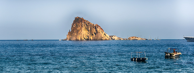 View of Dattilo's rock from the beach of Panarea, the smallest of the seven inhabited Aeolian Islands, Italy
