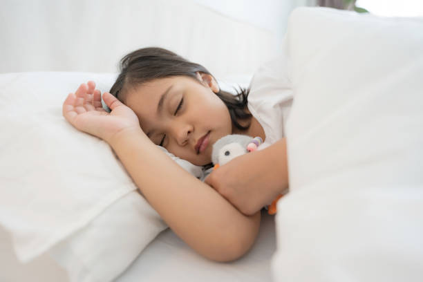 istock The girl sleeps in a comfortable white bedroom. 2148177193