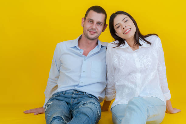 istock Couple smiling and sitting together on floor. 2148178204