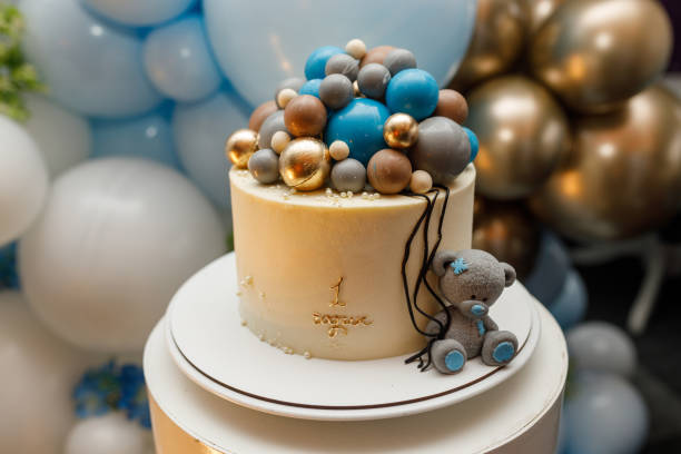 istock birthday cake with blue chocolate balls and teddy bear figurine 2148179804