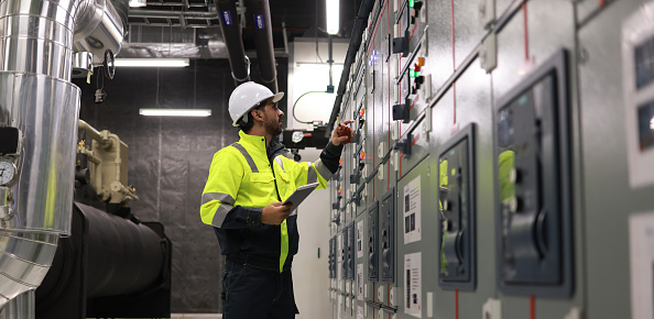 Engineers working in the main control room of a state-of-the-art chiller HVAC system.