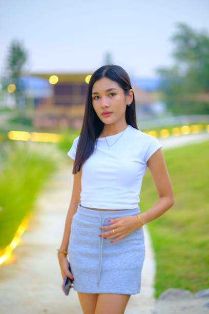 Young woman walking on the green grass hillside path