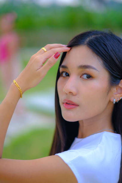 Young woman walking on the green grass hillside path