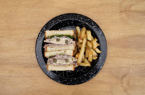 A vitel tone meat sandwich with fries