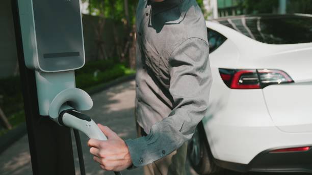 istock Young man recharge EV electric car battery at condo innards 2148184047