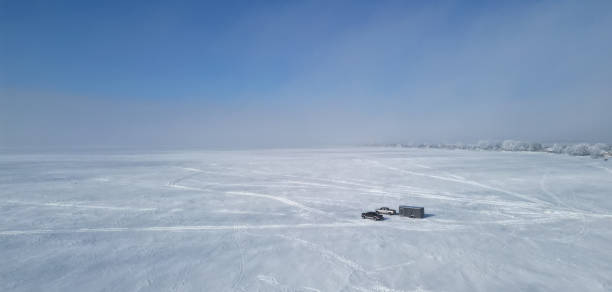 istock Snow covered field with truck 2148184133